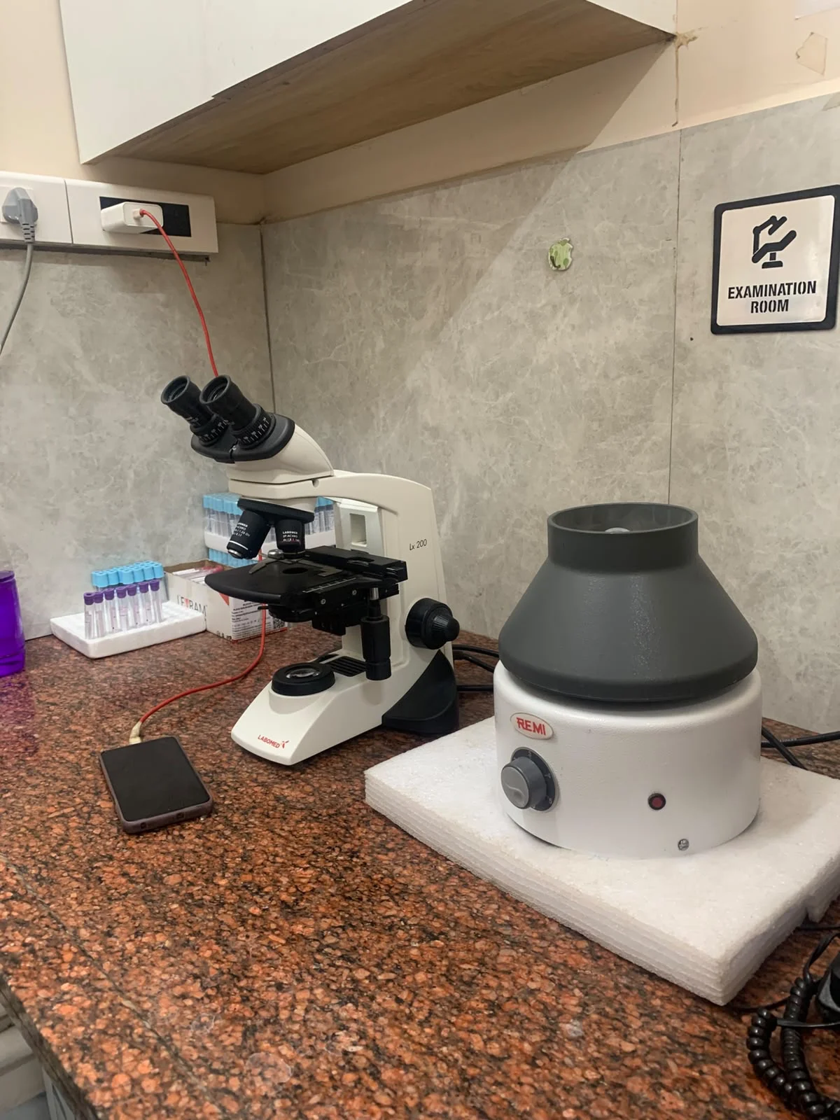 Microscope and centrifuge in the hospital laboratory examination room